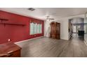 Spacious living room featuring wood-look floors, window shutters, and a ceiling fan at 3363 W Lone Cactus Dr, Phoenix, AZ 85027