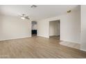 Spacious living room featuring wood floors, a ceiling fan, and neutral paint, offering a bright and airy atmosphere at 3363 W Lone Cactus Dr, Phoenix, AZ 85027