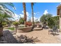 Inviting front courtyard with a charming seating area and mature landscaping, perfect for relaxing at 3801 N 154Th Ln, Goodyear, AZ 85395