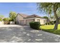 Home exterior featuring a spacious driveway, three-car garage, and well-maintained landscaping at 3950 E Mclellan Rd # 5, Mesa, AZ 85205