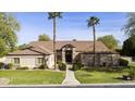 Charming single-story home showcasing mature landscaping, a welcoming entryway and lovely desert landscaping at 3950 E Mclellan Rd # 5, Mesa, AZ 85205