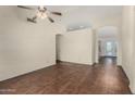 Spacious living area featuring vaulted ceilings, arched doorways, and beautiful hard wood flooring at 4622 E Fairbrook Cir, Mesa, AZ 85205