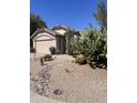 Charming desert landscaping with cacti and rock accents in this home's front yard at 4728 E Swilling Rd, Phoenix, AZ 85050