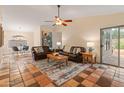 Warm and inviting living room featuring tile floors, comfortable seating, and a ceiling fan at 4728 E Swilling Rd, Phoenix, AZ 85050