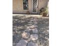 Stone pathway leading to the front door of a home with desert landscaping at 4728 E Swilling Rd, Phoenix, AZ 85050