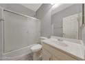 Bathroom featuring a shower-tub combo with glass doors, a toilet, and a vanity with sink at 6221 S 45Th Gln, Laveen, AZ 85339