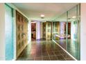 Unique foyer design featuring vintage carved doors and a mirrored accent wall at 7125 N 2Nd Pl, Phoenix, AZ 85020