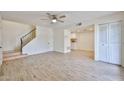 Bright living area with tile flooring, ceiling fan, staircase, and open access to the kitchen at 8130 N 32Nd Dr, Phoenix, AZ 85051