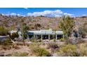 Stunning aerial view of a desert home nestled amongst the native landscape at 8619 E Silver Saddle Dr, Carefree, AZ 85377