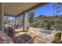 Relaxing covered patio with desert views and colorful lounge furniture at 8619 E Silver Saddle Dr, Carefree, AZ 85377