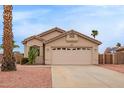 Charming single-story home features a two-car garage and manicured desert landscaping at 9176 W Calavar Rd, Peoria, AZ 85381