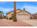 Single story home featuring desert landscaping, tile roof and two car garage at 9176 W Calavar Rd, Peoria, AZ 85381