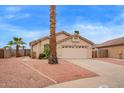 Single story home featuring desert landscaping, tile roof and two car garage at 9176 W Calavar Rd, Peoria, AZ 85381