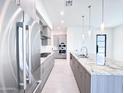 Modern kitchen featuring stainless steel appliances and a large center island with granite countertops at 1 Easy St # 7, Carefree, AZ 85377