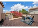 Relaxing outdoor patio area with table and chairs surrounded by desert landscaping at 12915 W Lone Tree Trl, Peoria, AZ 85383