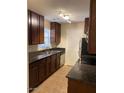 Traditional kitchen featuring dark cabinets, granite counters, and stainless steel appliances at 14145 N 92Nd St # 2004, Scottsdale, AZ 85260