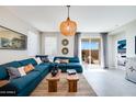 Stylish living room featuring a comfortable blue sectional and natural light at 14941 W Hackamore Dr, Surprise, AZ 85387