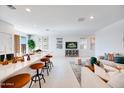 Open-concept living space with a kitchen island, white walls, and contemporary decor, creating an inviting atmosphere at 15033 W Hackamore Dr, Surprise, AZ 85387