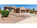 Charming home with desert landscaping, featuring a two car garage and neutral color scheme at 15696 W Roanoke Ave, Goodyear, AZ 85395