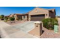 Home exterior featuring two-car garage, desert landscaping and charming mailbox at 15696 W Roanoke Ave, Goodyear, AZ 85395