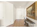 Inviting hallway with tile flooring, art, and a front door at 16100 W Galleria Ln, Surprise, AZ 85374