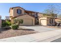 Beautiful stucco home with two garages, wrought iron gate, and low-maintenance landscaping at 17975 W Agave Rd, Goodyear, AZ 85338