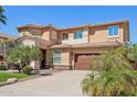 Inviting two-story home with lush landscaping, a well-maintained lawn, and an attached two-car garage at 18504 W Maui Ln, Surprise, AZ 85388