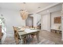 Elegant dining room with stylish chandelier, modern furnishings, and tile floors at 19699 E Apricot Ln, Queen Creek, AZ 85142