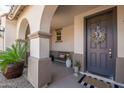 Covered front porch with decorative wreath, welcome bench, and manicured landscaping at 19699 E Apricot Ln, Queen Creek, AZ 85142