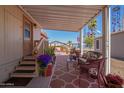 Inviting covered patio with comfortable seating and desert views at 201 S Greenfield Rd # 65, Mesa, AZ 85206