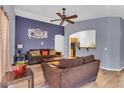 Comfortable living room with high ceilings, laminate flooring, and open access to the kitchen at 21655 N Davis Way, Maricopa, AZ 85138