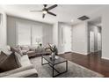 Inviting living room with wood floors, plantation shutters, and stylish furniture, bathed in natural light at 220 W Wood Dr, Chandler, AZ 85248