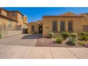 Inviting single-story home boasting desert landscaping, a brick driveway, and a quaint front entryway at 23133 N 73Rd Pl, Scottsdale, AZ 85255