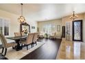 Elegant dining room featuring dark wood floors, a large mirror, and sophisticated decor at 2414 W Barbie Ln, Phoenix, AZ 85085