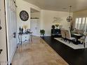 Open-concept living area showcasing travertine floors and natural light at 2414 W Barbie Ln, Phoenix, AZ 85085