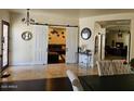 Spacious living room featuring stylish barn doors and elegant decor at 2414 W Barbie Ln, Phoenix, AZ 85085