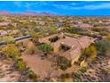 Overhead shot of an estate boasting a sprawling layout, beautiful desert landscaping, and mountain views at 27632 N 68Th Pl, Scottsdale, AZ 85266