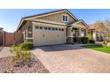 Beautiful home showcasing a brick driveway, well-maintained lawn, and charming exterior at 2807 W Canada De Oro Rd, Queen Creek, AZ 85144