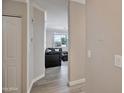 Hallway leading to a cozy living room with neutral walls and hardwood flooring, creating a seamless transition at 2992 N Miller Rd # A202, Scottsdale, AZ 85251