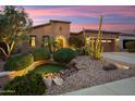 Charming home exterior with beautiful desert landscaping, enhancing curb appeal and creating a welcoming entrance at 30110 N 129Th Gln, Peoria, AZ 85383