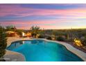 Stunning backyard pool surrounded by lush desert landscaping, offering a private and serene escape at 30110 N 129Th Gln, Peoria, AZ 85383