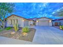 Beautiful single-story home with a two-car garage, desert landscaping, and charming curb appeal at 30550 N 125Th Dr, Peoria, AZ 85383