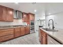 Well-equipped kitchen with granite countertops, stainless appliances, and wood cabinetry at 3224 E Sweetwater Ave, Phoenix, AZ 85032