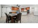 Open kitchen and dining area with stainless steel appliances, cabinets, and tile flooring at 3224 E Sweetwater Ave, Phoenix, AZ 85032