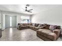 Bright living room featuring a large sectional couch and wood-look tile floors at 3224 E Sweetwater Ave, Phoenix, AZ 85032