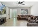 Comfortable living room features tile floors, a ceiling fan, and a large sectional sofa at 3224 E Sweetwater Ave, Phoenix, AZ 85032