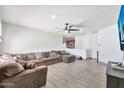 Open concept living room showcasing wood-look tile floors and white walls at 3224 E Sweetwater Ave, Phoenix, AZ 85032