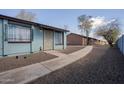 Blue apartment with decorative bars, rock landscaping, concrete walkway, and secure doorway at 3646 N 67Th Ave # 12, Phoenix, AZ 85033