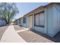 A neat row of single-story apartments, each with security bars, in a well-maintained complex at 3646 N 67Th Ave # 12, Phoenix, AZ 85033