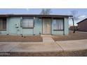 Charming blue apartment with decorative bars, rock landscaping, and a concrete walkway at 3646 N 67Th Ave # 12, Phoenix, AZ 85033